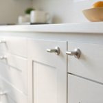Kitchen showing multiple cabinet D handles in brushed nickel finish