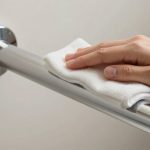 Person cleaning D handle with microfiber cloth showing proper maintenance