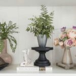 A styled shelf showing the MintpalDecor home hack of editing to odd numbers — three objects at varying heights creating a naturally balanced vignette. Clean, deliberate, beautiful.