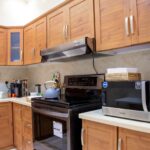 Kitchen with poor cabinet placement before renovation correction